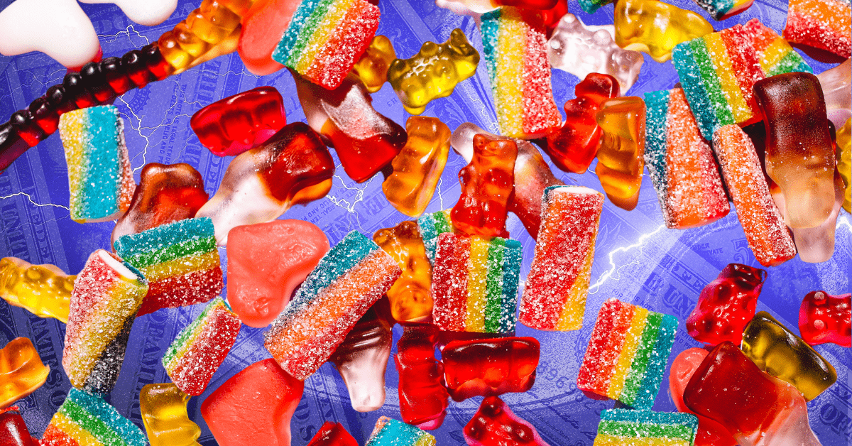 A variety of multicolored gummy candy on a purple background.